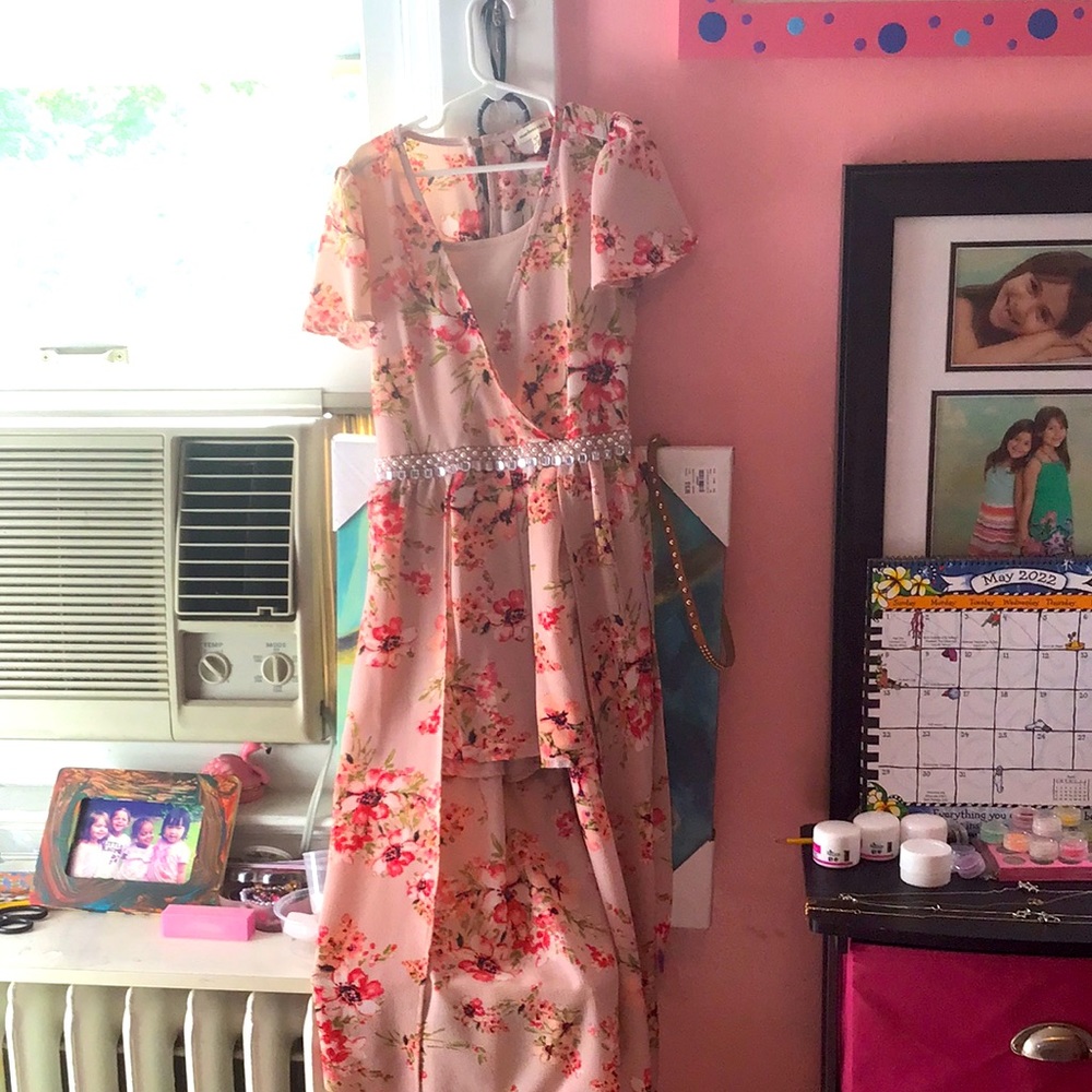 This is a Monteau Girl romper that has floral design and a cute waist strap.